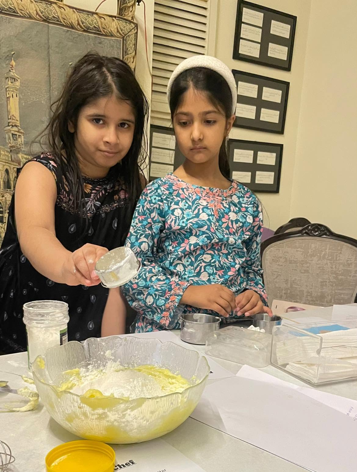 Child measuring ingredients during a practical cooking activity